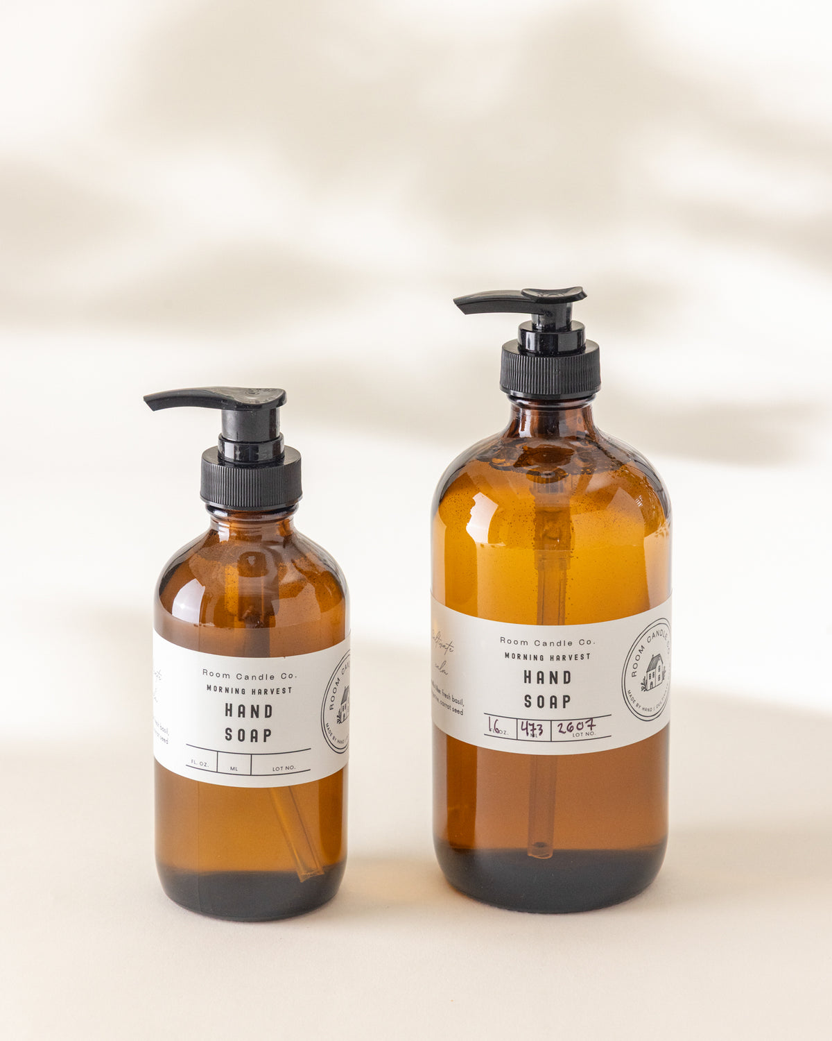 Two sizes of Morning Harvest Liquid Hand Soap by Room Candle Co. displayed side by side against a plain background.